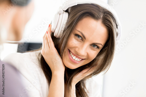 Young woman in the office with headphones