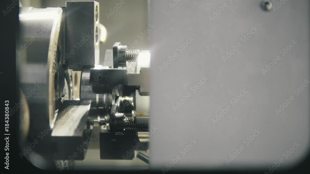 Placing the metal parts in the lathe for machining Placing the metal parts in the lathe for machining