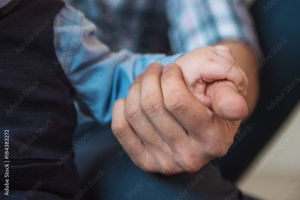 Dad is holding his son's hand Dad is holding his son's hand