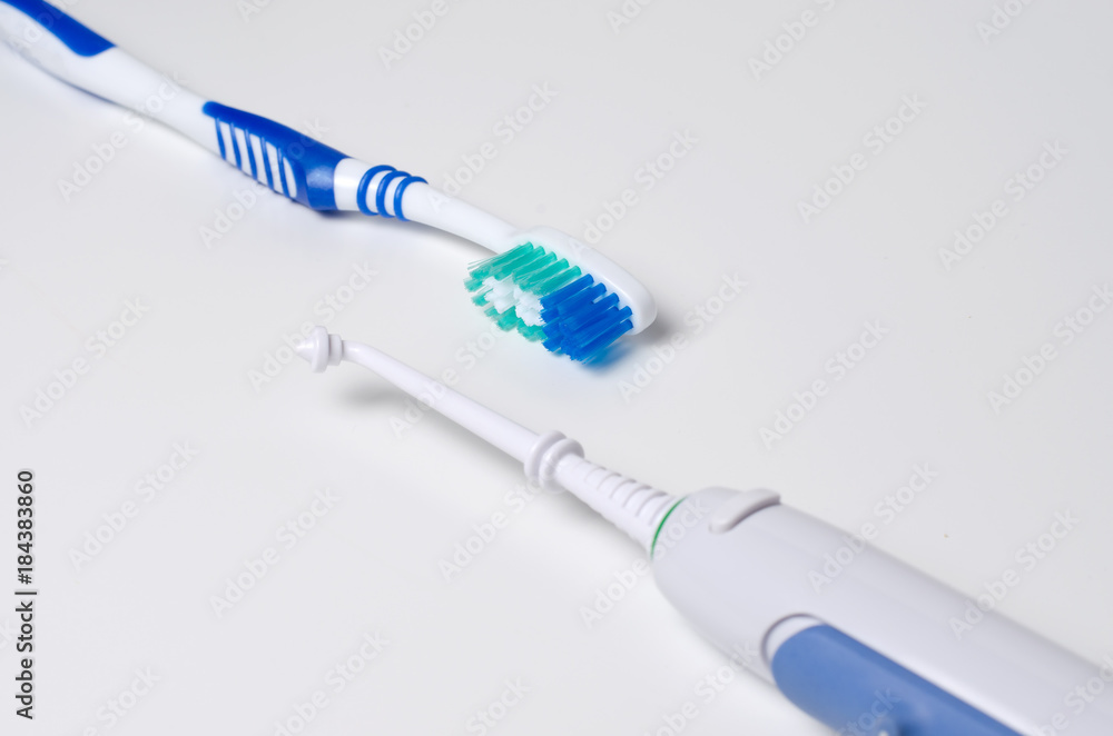 Dental hygiene. Toothbrush, oral irrigator on a white background Dental hygiene. Toothbrush, oral irrigator on a white background