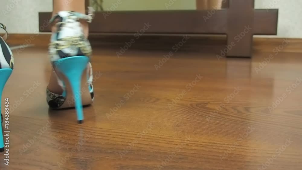 The legs of a little girl in sandals with heels. The legs of a little girl in sandals with heels.
