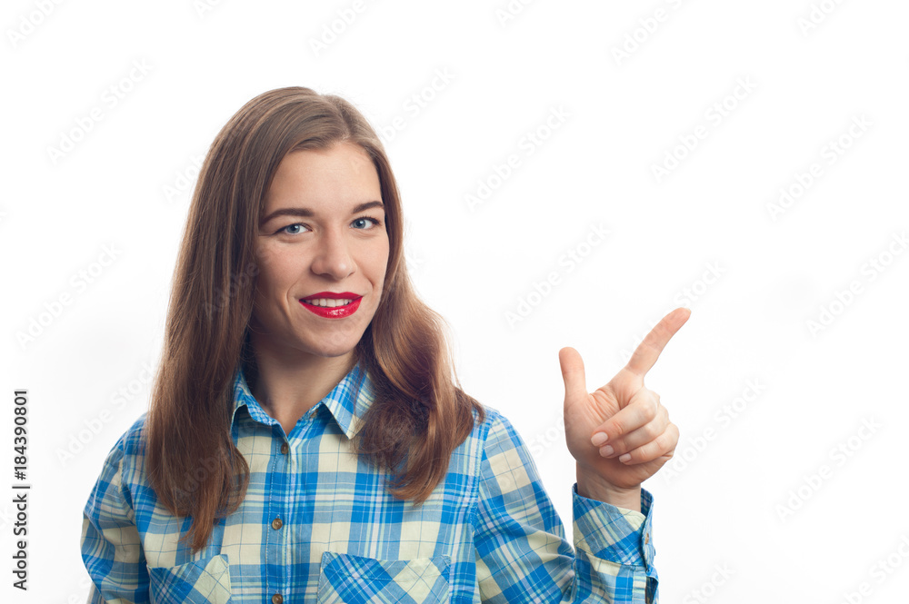 Portrait of a smiling caucasian woman with long hair in plaid shirt pointing finger to blank space on a white background Portrait of a smiling caucasian woman with long hair in plaid shirt pointing finger to blank space on a white background