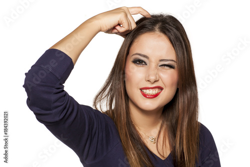 Portrait of confused positive young woman on white background