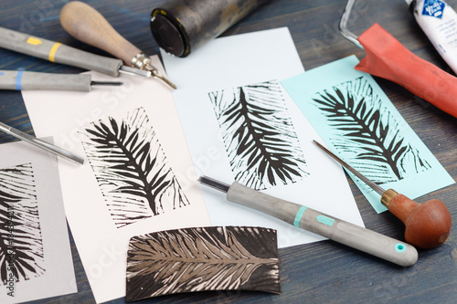 Greeting card on a dark wooden shabby background with old art tools. Close up