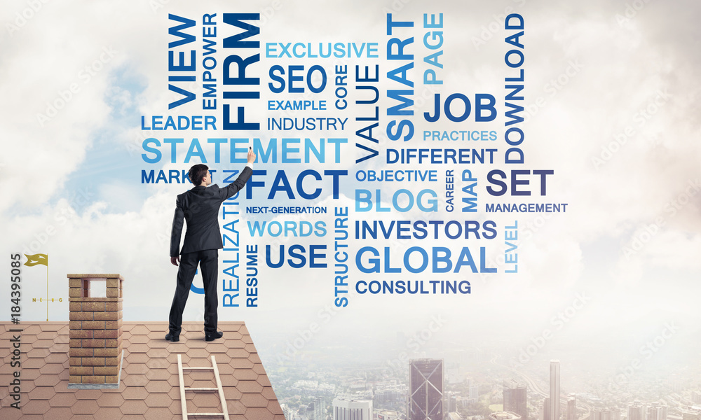 Young businessman standing on house roof and writing leadership Young businessman standing on house roof and writing leadership