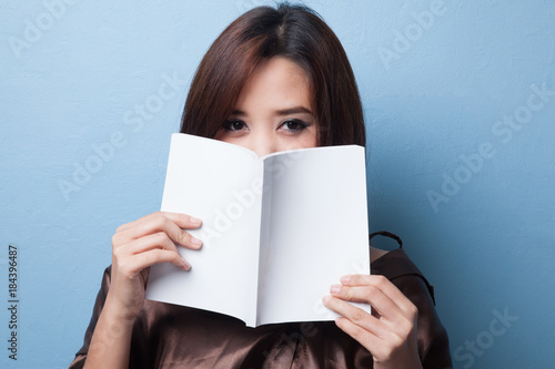 Young Asian woman with a book. © halfbottle