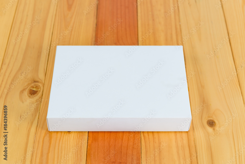 Empty white gift on wooden table with copy space. Empty white gift on wooden table with copy space.