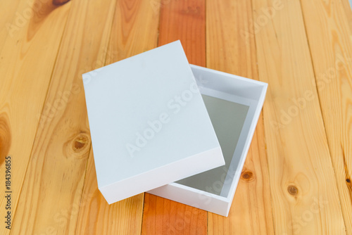 Empty white gift on wooden table with copy space.