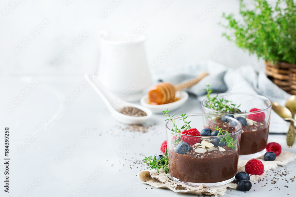 Healthy vegan chocolate chia pudding with berries and green thyme Healthy vegan chocolate chia pudding with berries and green thyme