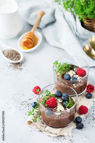 Healthy vegan chocolate chia pudding with berries and green thyme