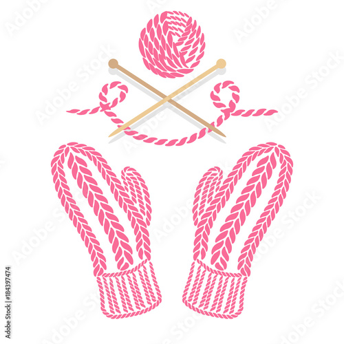 Pink knitted winter mittens, wood needles and wool ball