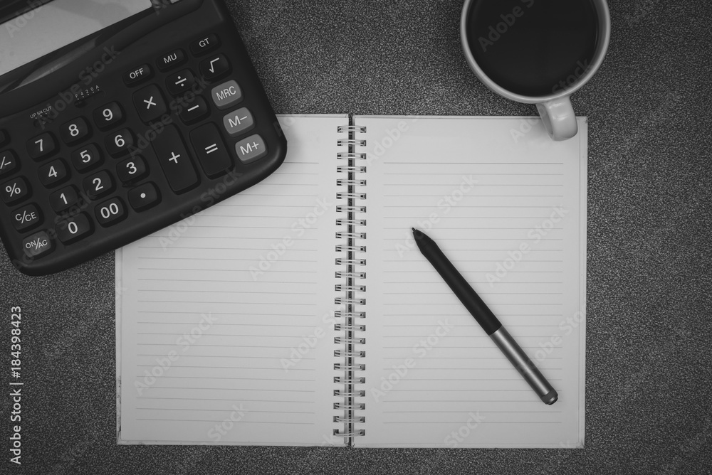 Calculator and cup of coffee with note on working table with copy space top view. Calculator and cup of coffee with note on working table with copy space top view.