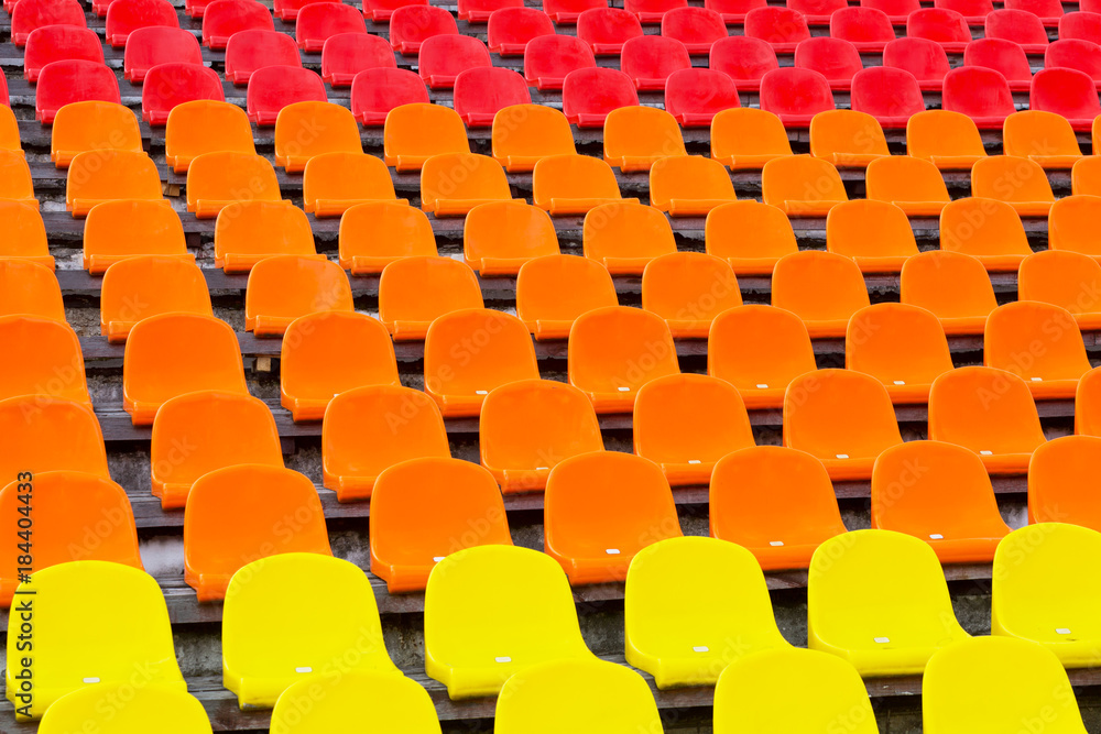 Fototapeta premium Wielokolorowe plastikowe krzesła na stadionie