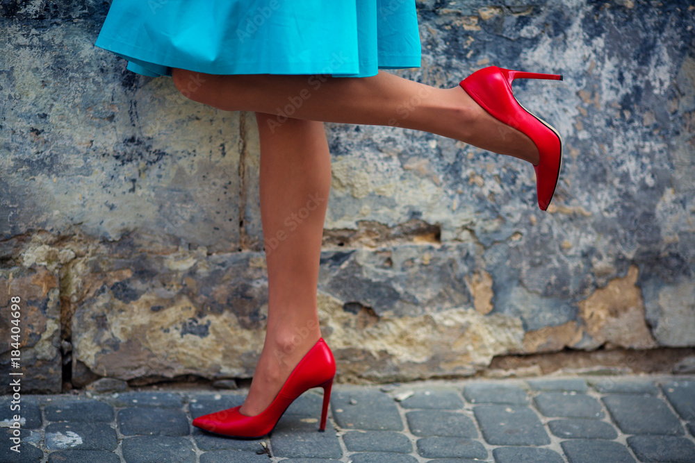 Walking female legs red shoes blue dress woman lower half