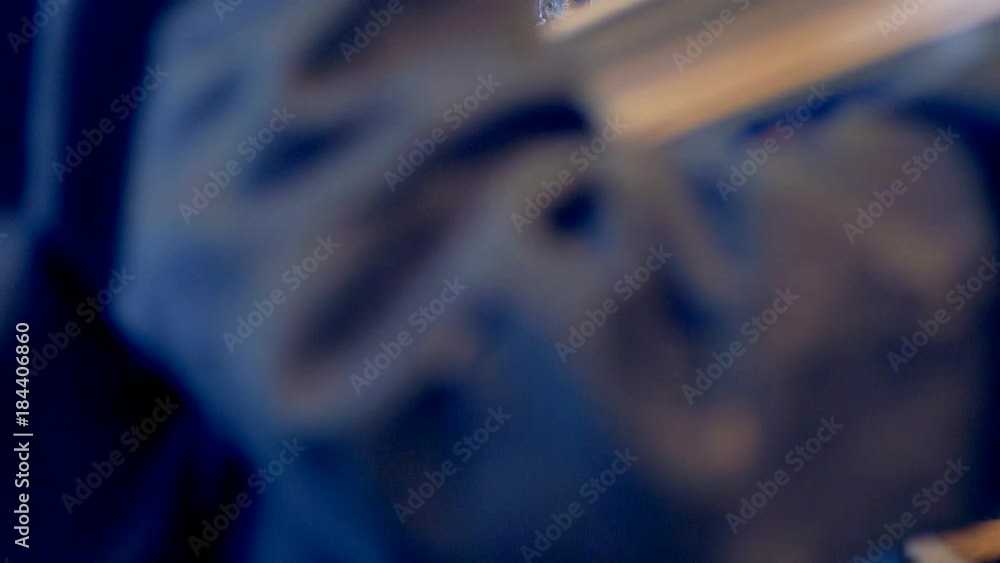 Worker at industrial machine processing plastic detail. Worker at industrial machine processing plastic detail.