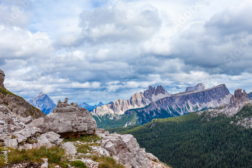 Stone men with awesome Croda da Lago and Lastroi de Formin Mounts background, Dolomites, Italy