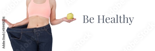 Be healthy text and fit woman holding apple in oversized