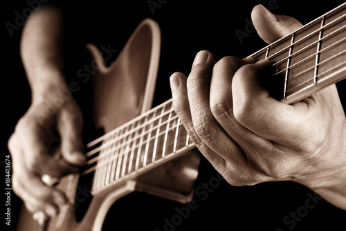 guitarist playing country guitar, sepia image photo