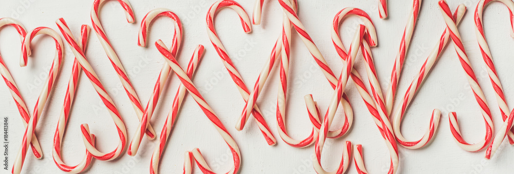 Christmas holiday red candy cane pattern, texture and background on white background, flat-lay, copy space, wide composition Christmas holiday red candy cane pattern, texture and background on white background, flat-lay, copy space, wide composition