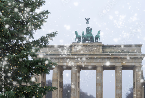 Canvas Print Bradenburg Gate with Christmas tree at winter day with falling snow, Berlin, Ger