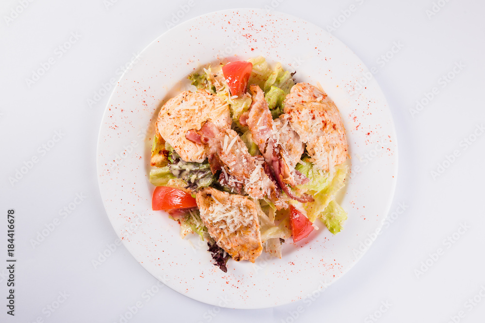 salad with bacon and chicken on a white plate on a light background (close top view) salad with bacon and chicken on a white plate on a light background (close top view)
