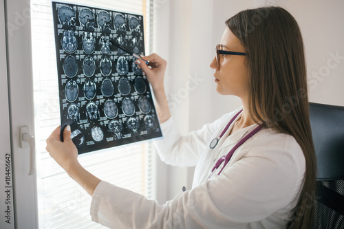 Young female doctor looking at mri scan