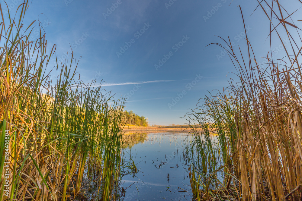 Autumn colorful landscape and lake reflection and blue sky Autumn colorful landscape and lake reflection and blue sky