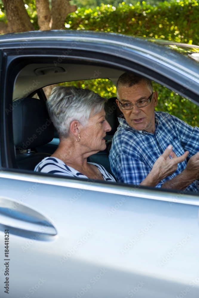 Senior couple talking in car