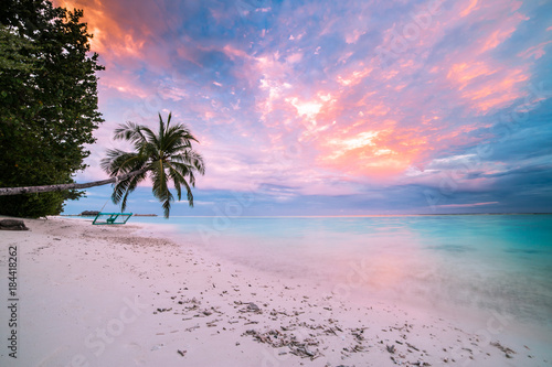 Tropical beach sunset, calm sea, sunset sky and clouds