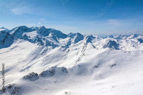 Winter snow covered mountain peaks Austrian alps © Kotangens