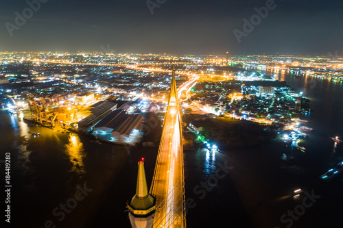 Aerial top view night traffic bridge river side with city