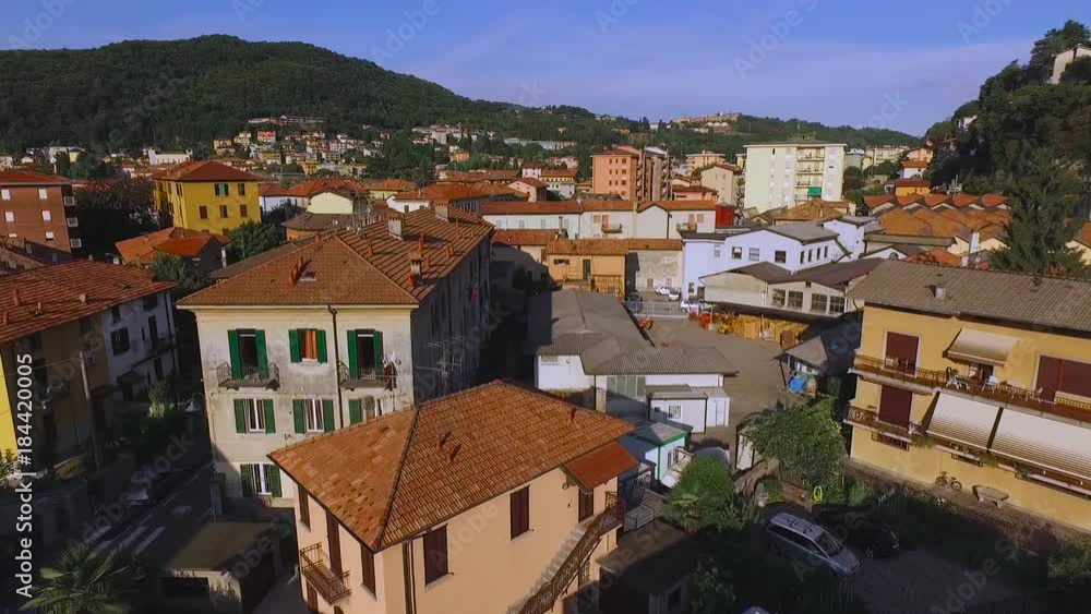 A small city in Italy against the backdrop of the mountains.