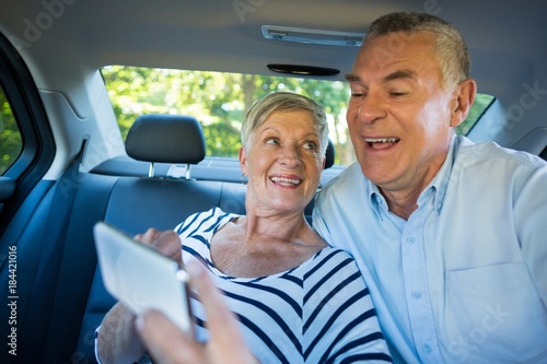 Senior couple using mobile phone in car © WavebreakMediaMicro