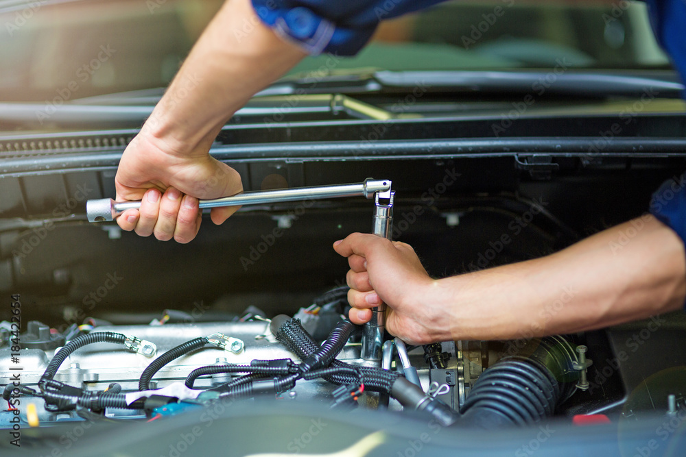 Hands of mechanic working in auto repair shop
Hands of mechanic working in auto repair shop