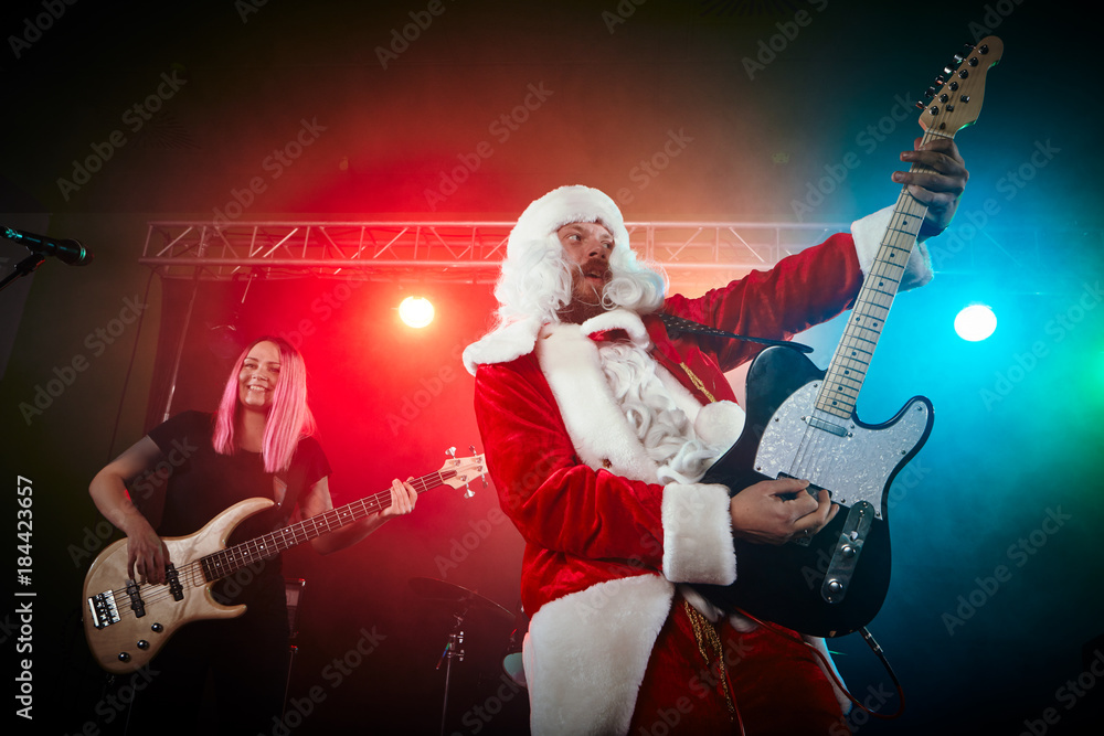Obraz premium Santa Claus plays rock.