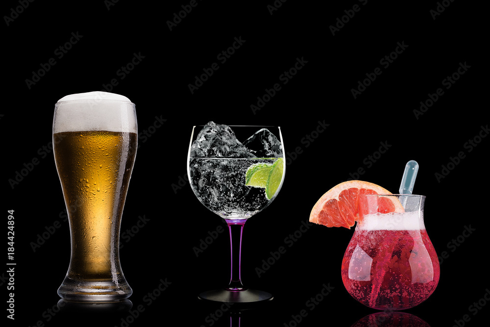 Selection of cocktails martini spritz bramble gin tonic beer bramble bar blurred black background