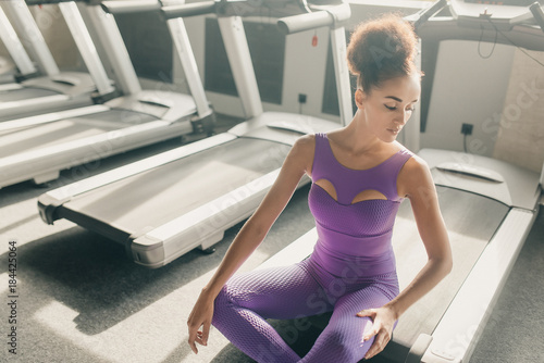 Beautiful tired sexy woman on a treadmill in the gym after a workout. sports and leisure. © vitleo