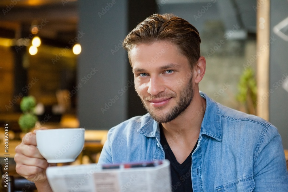 Portrait of handsome man holding coffee cup Portrait of handsome man holding coffee cup