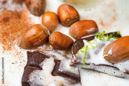 Hazelnut and chocolate in spilled milk.