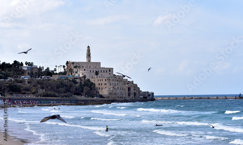 Israel , view of Old City Jaffa Jafo port skyline sea waves breakers wall bay beach sand from Tel Aviv photo