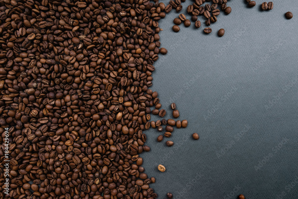 Coffee beans on the dark grey background, half Coffee beans on the dark grey background, half
