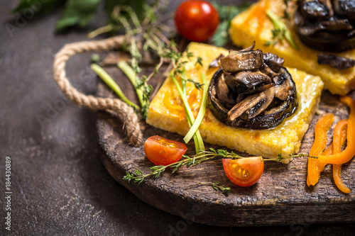 Vászonkép corn polenta with roasted mushrooms and eggplant, traditional Italian food with