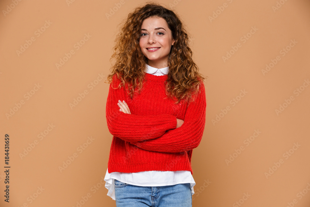 Portrait of a smiling young girl standing with arms folded Portrait of a smiling young girl standing with arms folded