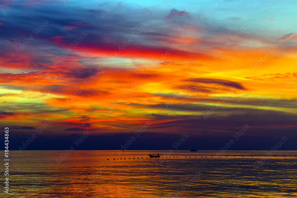 Tropical Sunset or Sunrise with reflection in water, colorful clouds