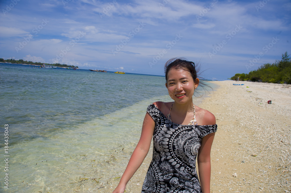 happy Asian Chinese woman in Summer dress walking on beautiful Thailand island beach under a blue sky in holiday happy Asian Chinese woman in Summer dress walking on beautiful Thailand island beach under a blue sky in holiday