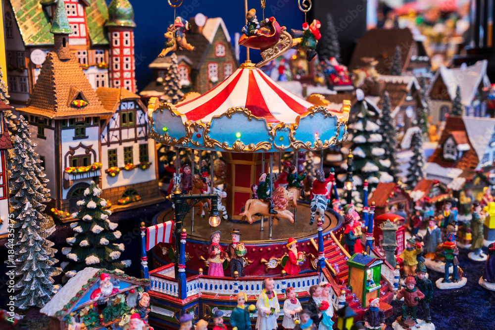 Christmas market kiosk details - coloful traditional german houses and merry go round