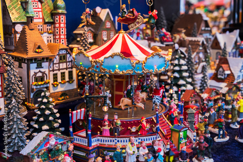 Christmas market kiosk details - coloful traditional german houses and merry go round