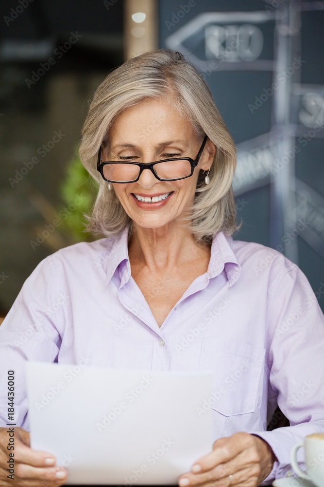 Happy senior woman holding tablet computer 