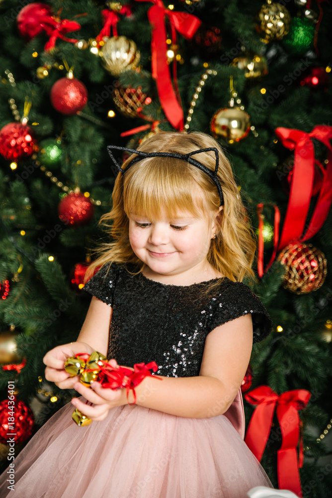 little cute girl decorate christmas tree