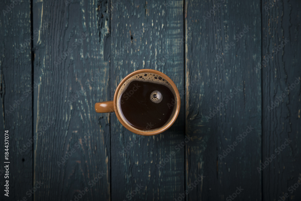 Fototapeta premium Coffee cup and beans on old kitchen table. Top view with copyspace for your text